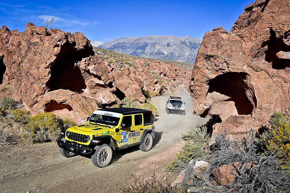 Jeep driving on dirt trail in desert